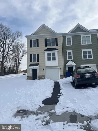 a car parked in front of white house