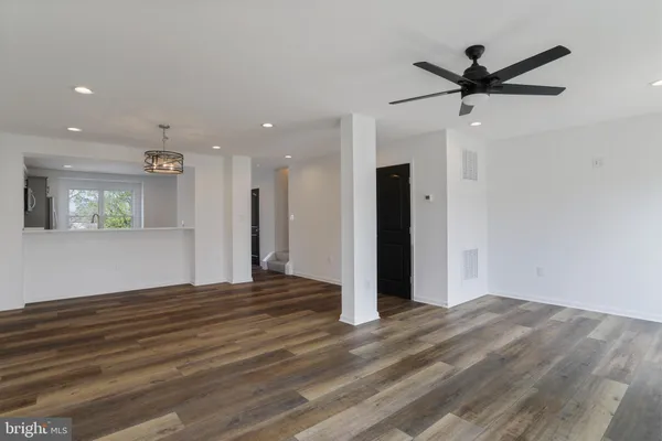 a view of a livingroom with a ceiling fan & window
