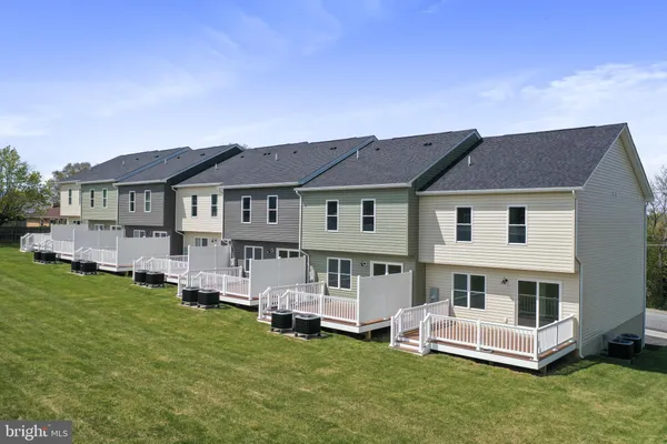 a view of a house with a yard and sitting area