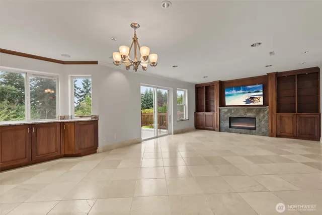 a large kitchen with a window and a refrigerator