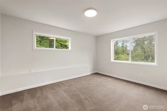 a bathroom with a granite countertop sink a toilet and shower