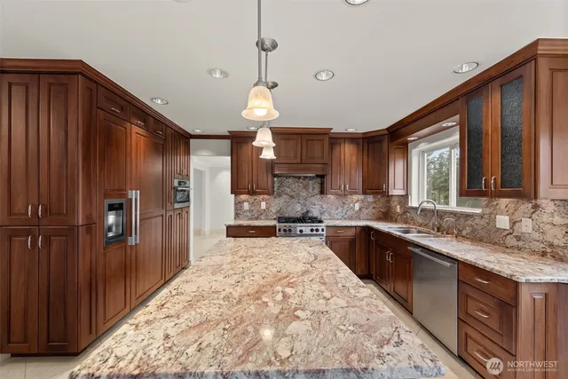 a kitchen with stainless steel appliances granite countertop a stove and a refrigerator