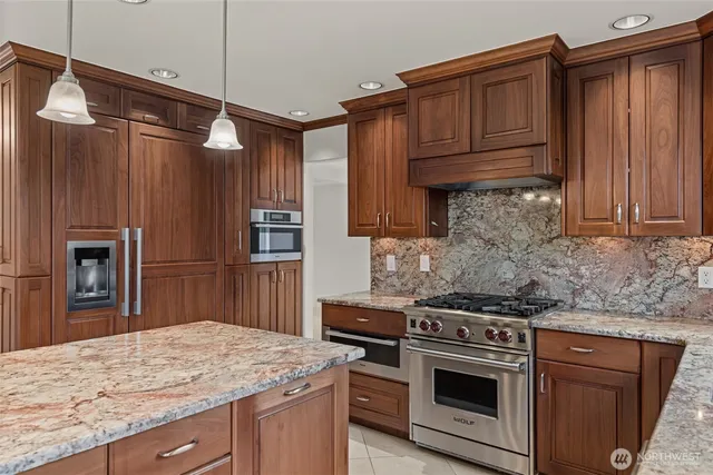 a kitchen with granite countertop counter space a sink and a large window