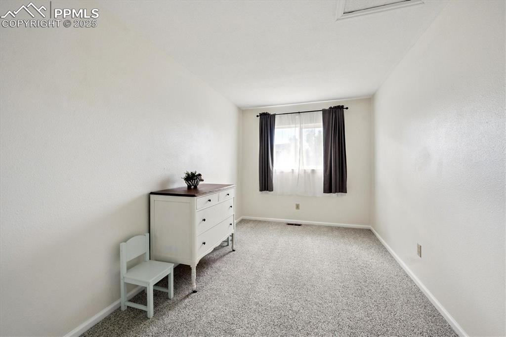 704 Madison Way Bennett, CO 80102 - Photo 14 of 29 a room with a chair and a window