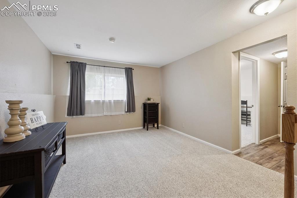 704 Madison Way Bennett, CO 80102 - Photo 15 of 29 a view of an empty room with a window