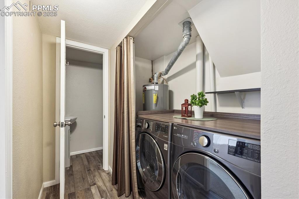 704 Madison Way Bennett, CO 80102 - Photo 17 of 29 a view of a storage and utility room with washer and dryer