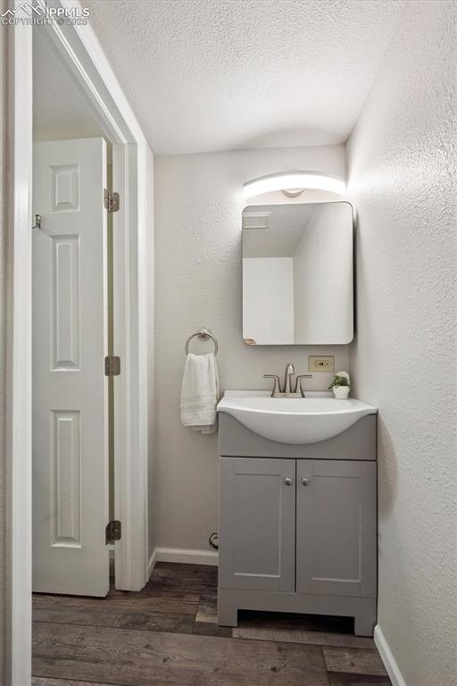 704 Madison Way Bennett, CO 80102 - Photo 18 of 29 a bathroom with a sink and a mirror