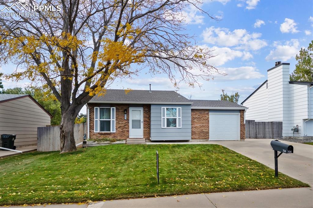 704 Madison Way Bennett, CO 80102 - Photo 2 of 29 a view of a house with a yard