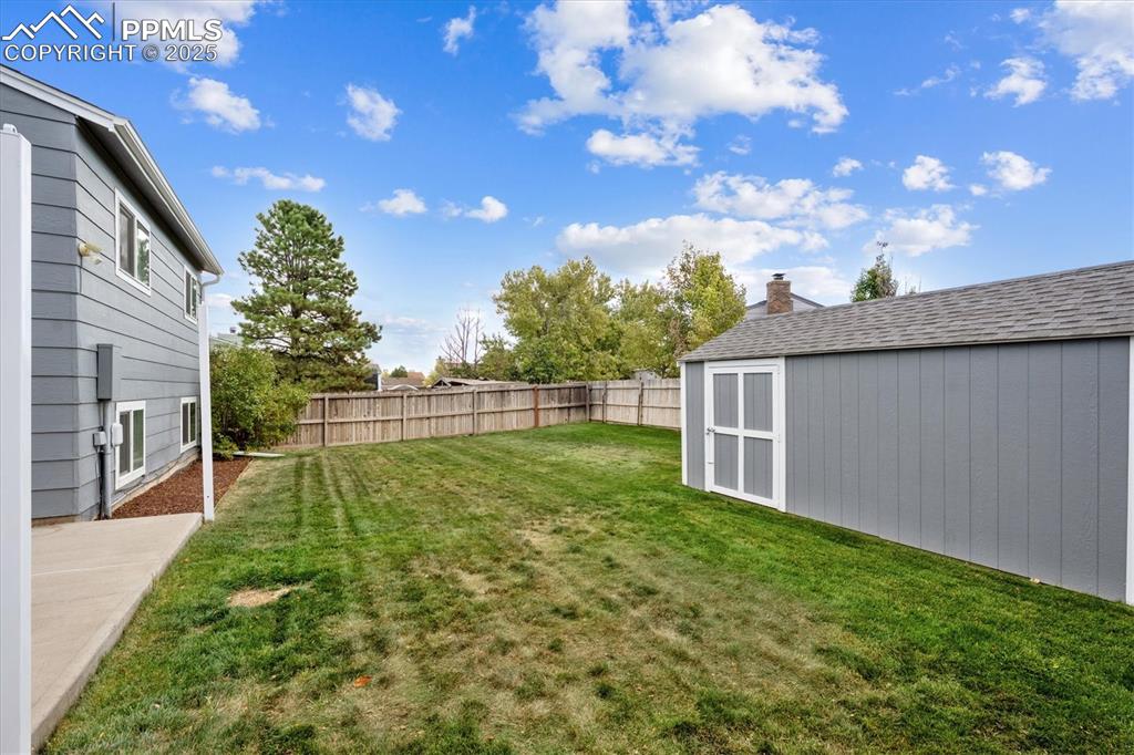 704 Madison Way Bennett, CO 80102 - Photo 21 of 29 a view of backyard with garden