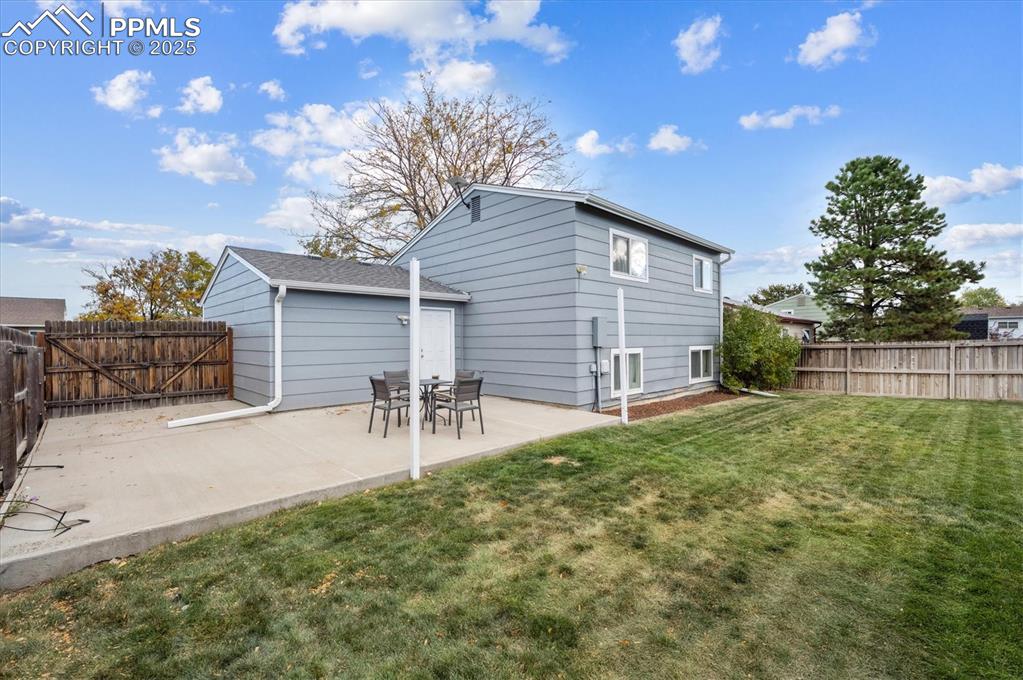 704 Madison Way Bennett, CO 80102 - Photo 22 of 29 a backyard of a house with table and chairs