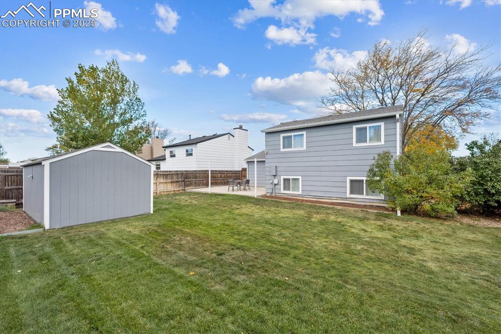 704 Madison Way Bennett, CO 80102 - Photo 23 of 29 a front view of house with yard and trees in the background