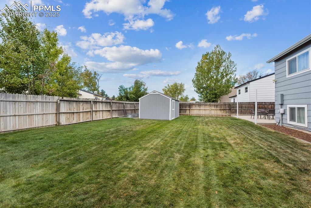 704 Madison Way Bennett, CO 80102 - Photo 24 of 29 a view of backyard with green space