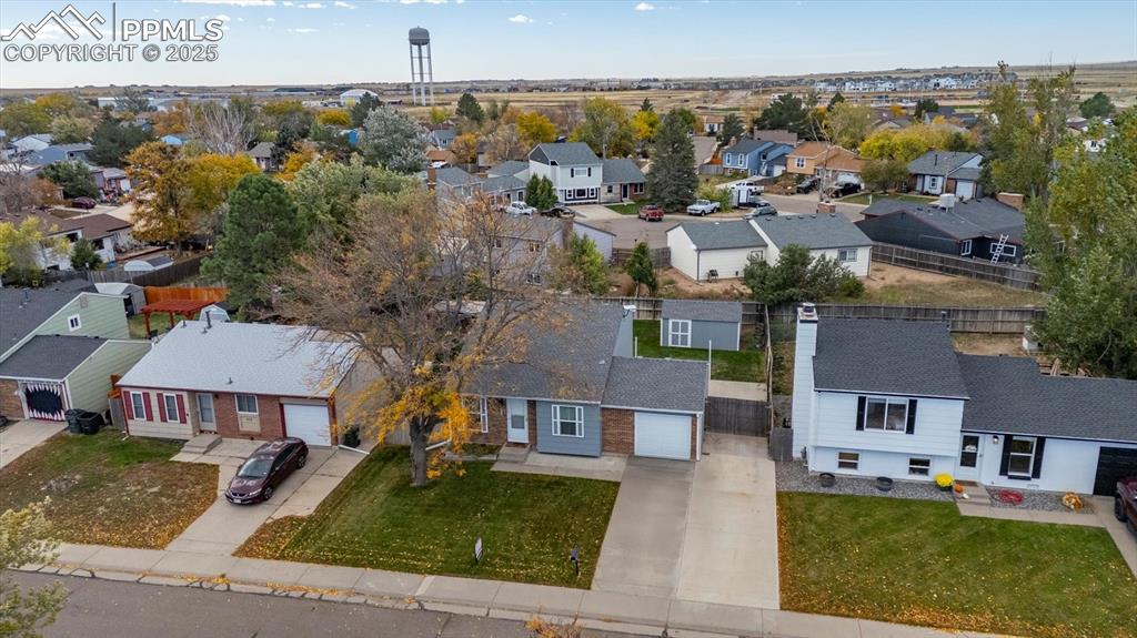 704 Madison Way Bennett, CO 80102 - Photo 25 of 29 an aerial view of multiple houses with a yard