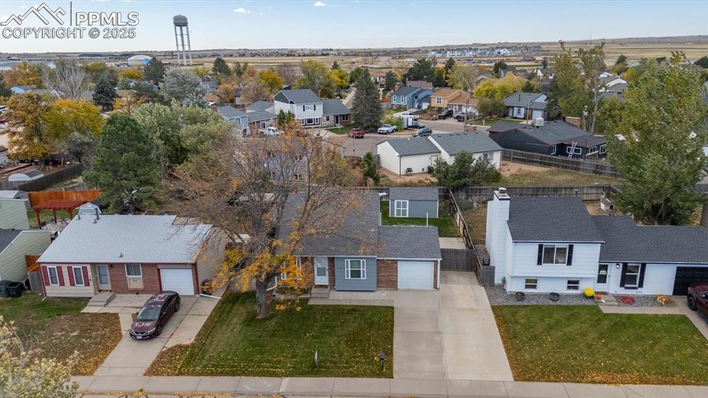 704 Madison Way Bennett, CO 80102 - Photo 26 of 29 an aerial view of residential houses with outdoor space and parking