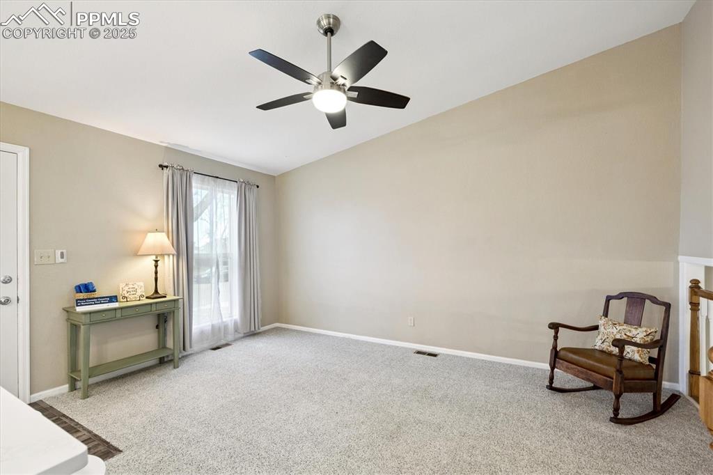 704 Madison Way Bennett, CO 80102 - Photo 4 of 29 an empty room with windows and fan