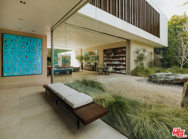 a view of a patio with table and chairs with wooden floor and plants