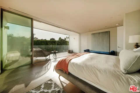 a bedroom with a bed and a couch