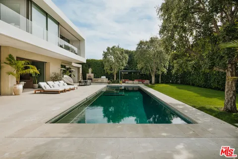 a terrace with outdoor seating and trees