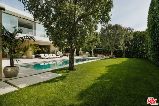 a view of house with outdoor space and swimming pool