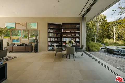 a living room with furniture and a floor to ceiling window