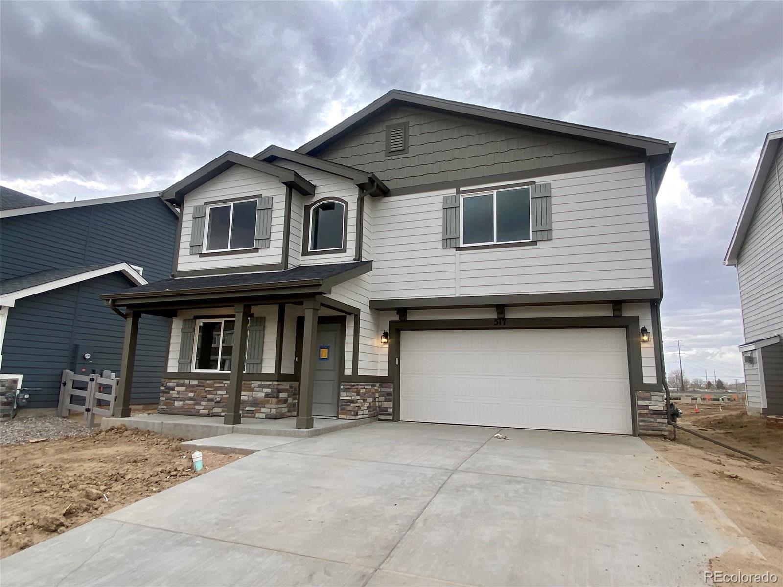 a front view of a house with garage