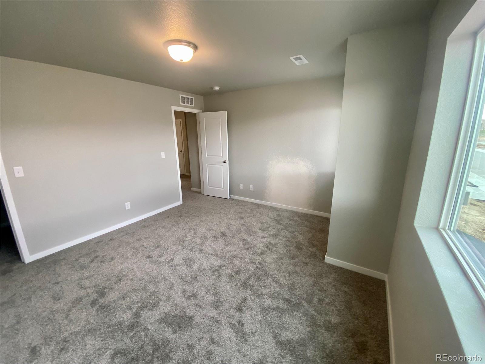517 Ryan Avenue Fort Lupton, CO 80621 - Photo 11 of 21 an empty room with windows and entrance