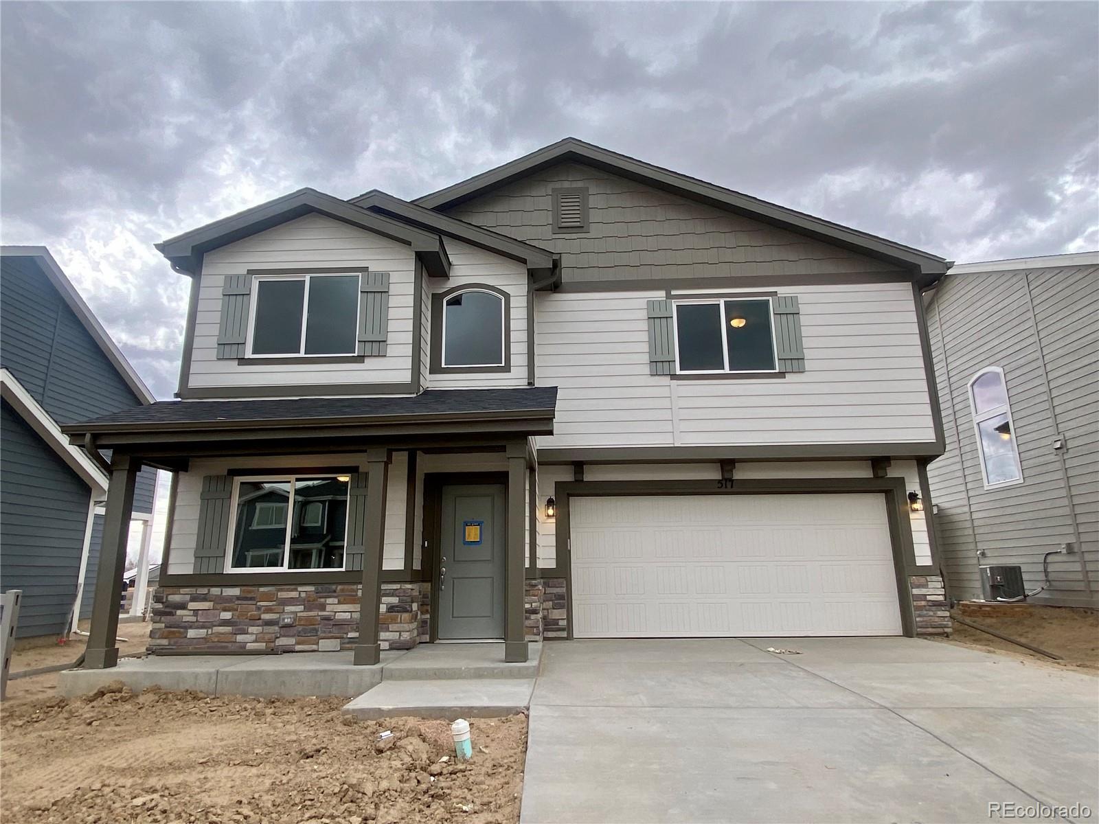 517 Ryan Avenue Fort Lupton, CO 80621 - Photo 2 of 21 a front view of a house with garden