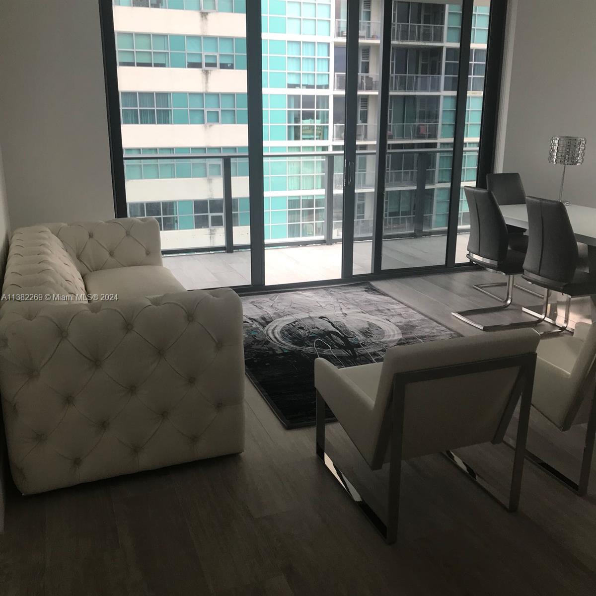 121 Northeast 34th Street, Unit 2601 Miami, FL 33137 - Photo 5 of 10 a bedroom with a bed and a window