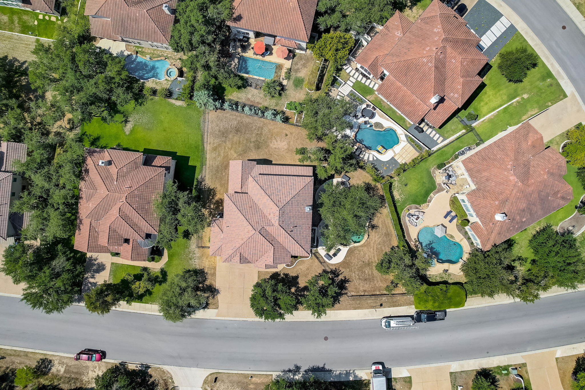 16012 Spillman Ranch Loop Austin, TX 78738 - Photo 4 of 38 An aerial perspective reveals a captivating neighborhood with numerous residences, each featuring a private pool and mature trees.