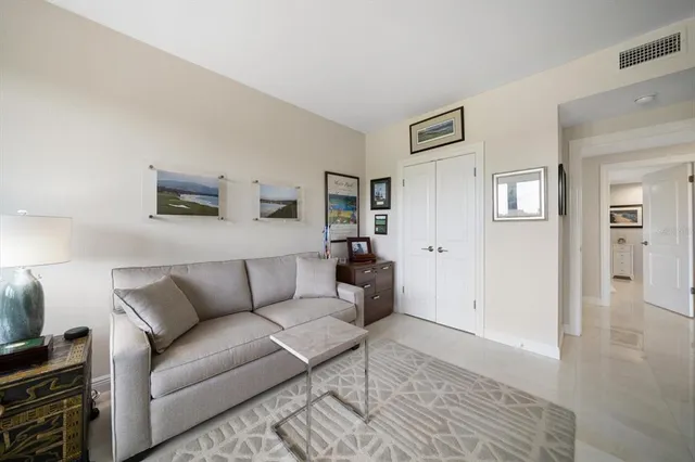 a living room with furniture and painting on the wall