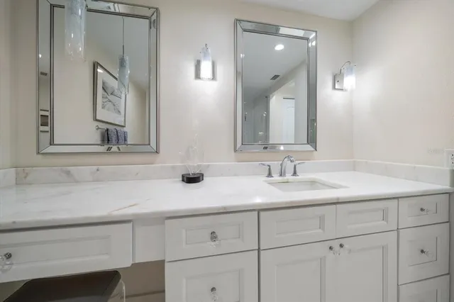 a bedroom with a large bed and a flat screen tv