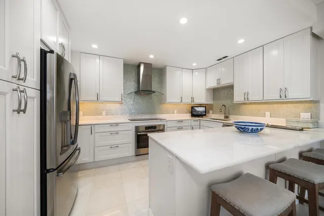 a kitchen with a refrigerator a stove a sink and a refrigerator