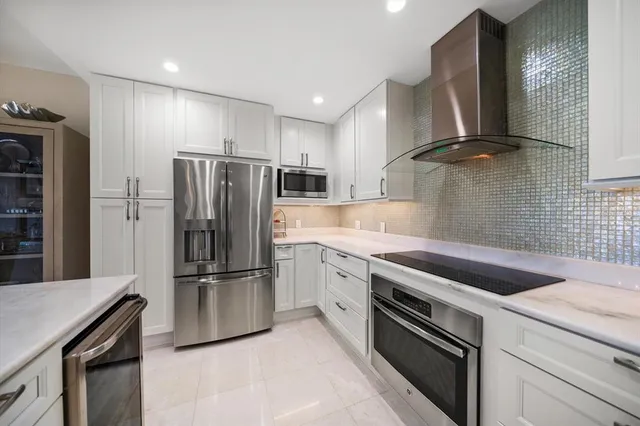 a kitchen with a sink stainless steel appliances and cabinets