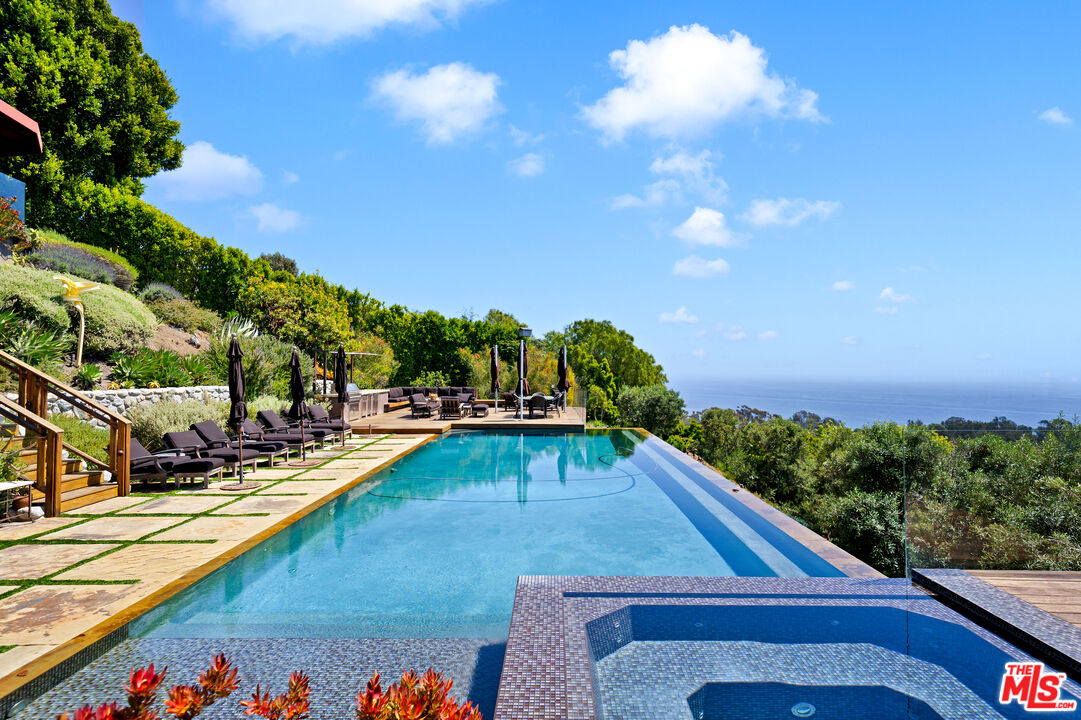 a view of a swimming pool with an outdoor seating