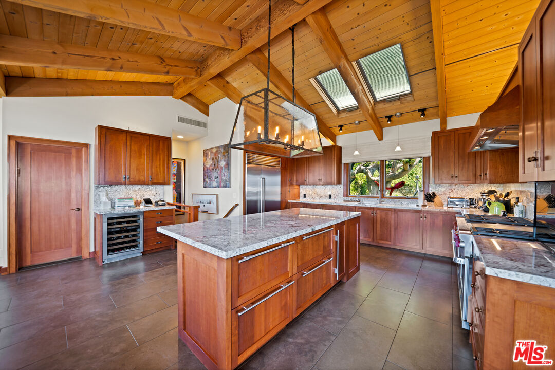 27434 Winding Way Malibu, CA 90265 - Photo 11 of 39 a kitchen with stainless steel appliances granite countertop a stove a sink and a refrigerator