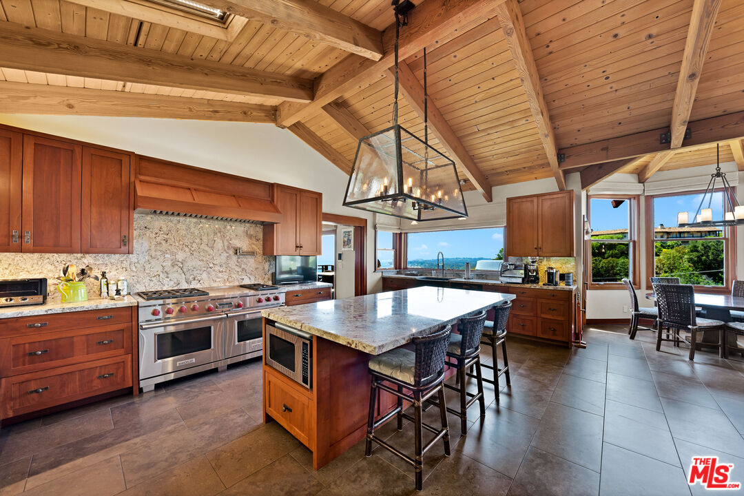 27434 Winding Way Malibu, CA 90265 - Photo 12 of 39 a kitchen with stainless steel appliances granite countertop a stove a sink and a refrigerator
