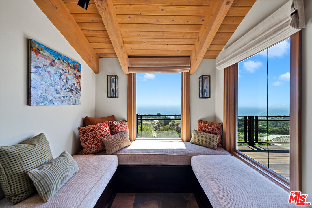 27434 Winding Way Malibu, CA 90265 - Photo 15 of 39 a living room with furniture and a floor to ceiling window