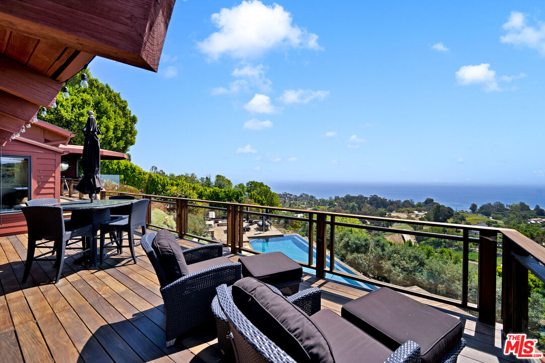 27434 Winding Way Malibu, CA 90265 - Photo 16 of 39 a view of a balcony with wooden floor and outdoor seating