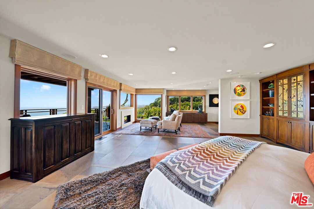 27434 Winding Way Malibu, CA 90265 - Photo 18 of 39 a living room with furniture and a flat screen tv