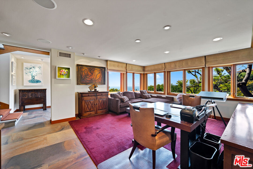 27434 Winding Way Malibu, CA 90265 - Photo 20 of 39 a living room with furniture a rug and a large window