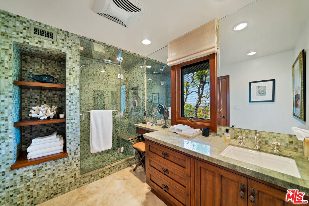 27434 Winding Way Malibu, CA 90265 - Photo 22 of 39 a bathroom with a double vanity sink and a mirror