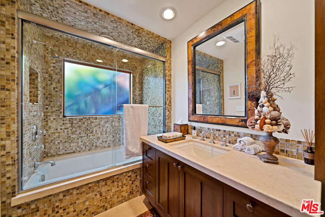 27434 Winding Way Malibu, CA 90265 - Photo 24 of 39 a bathroom with a double vanity sink mirror and shower