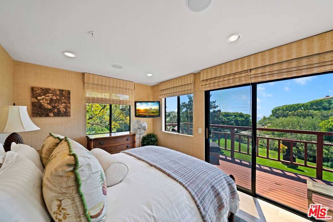 27434 Winding Way Malibu, CA 90265 - Photo 29 of 39 a bedroom with large window and a bed