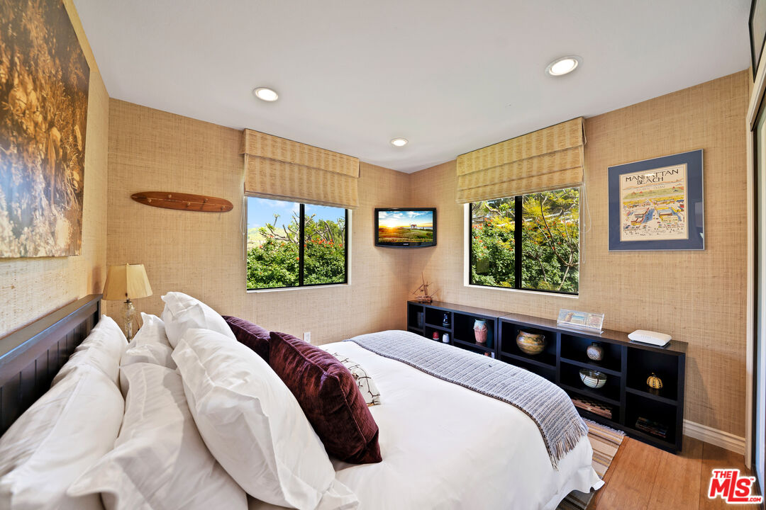 27434 Winding Way Malibu, CA 90265 - Photo 30 of 39 a bedroom with a bed and a window