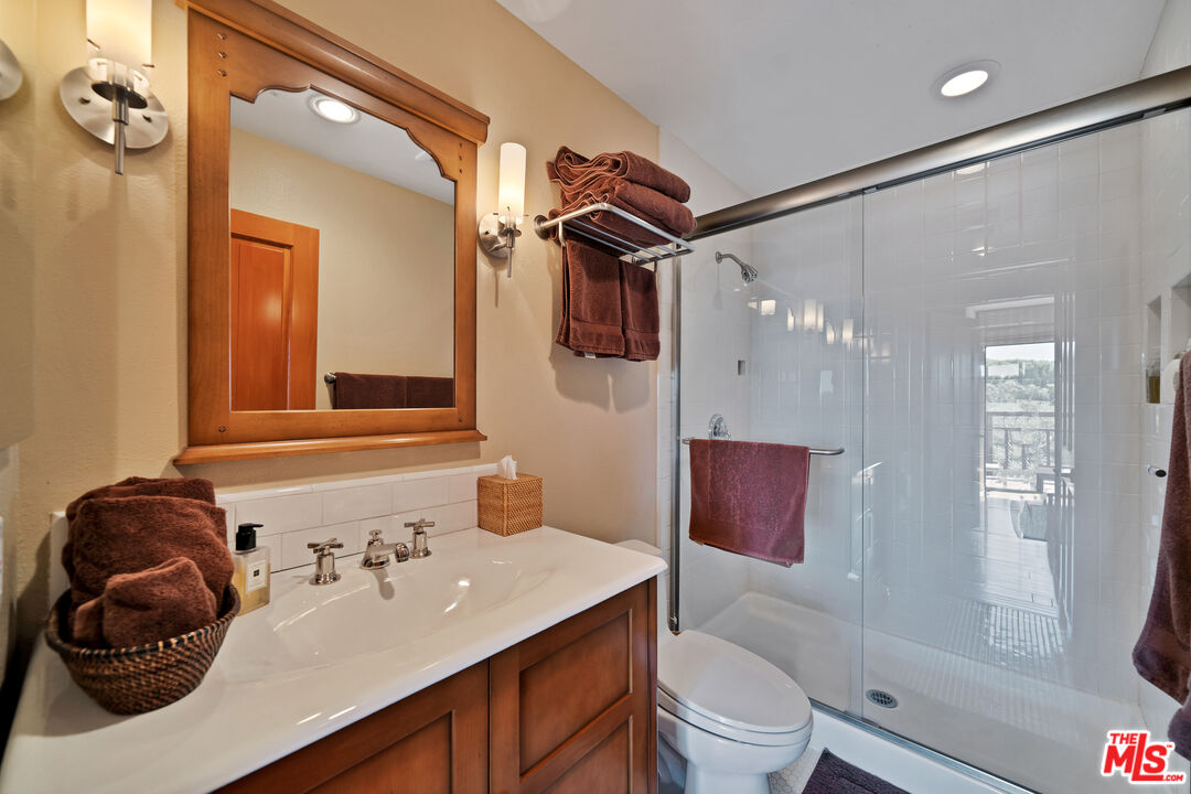 27434 Winding Way Malibu, CA 90265 - Photo 31 of 39 a bathroom with a sink toilet and shower