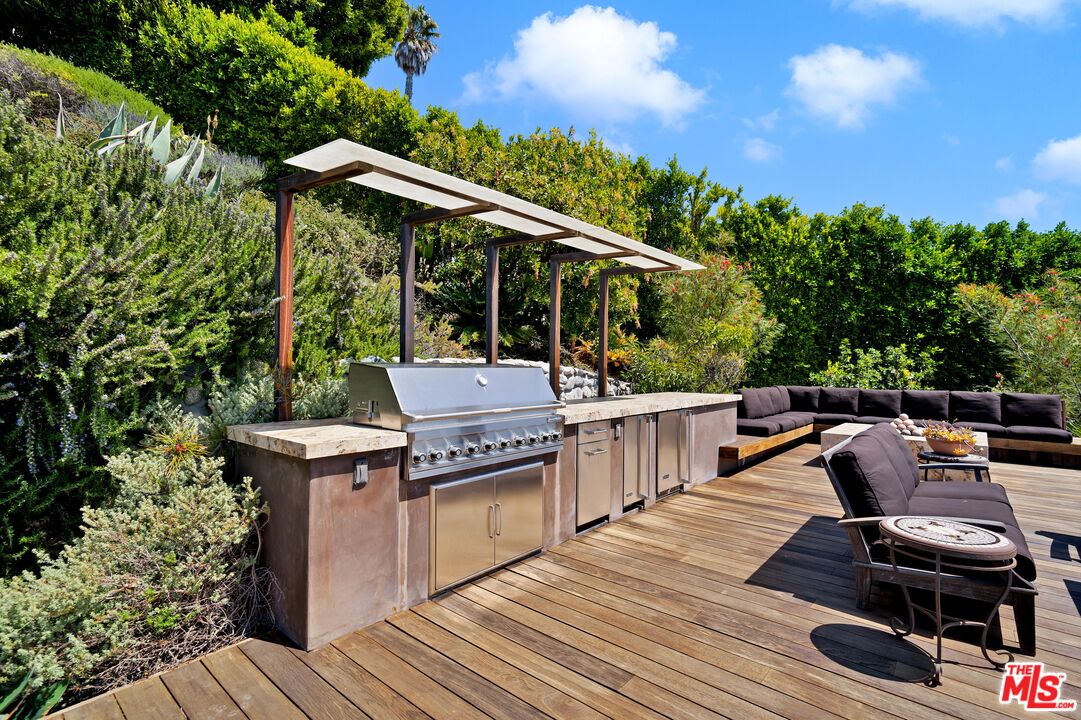 27434 Winding Way Malibu, CA 90265 - Photo 37 of 39 a view of a chairs and table on the wooden roof deck