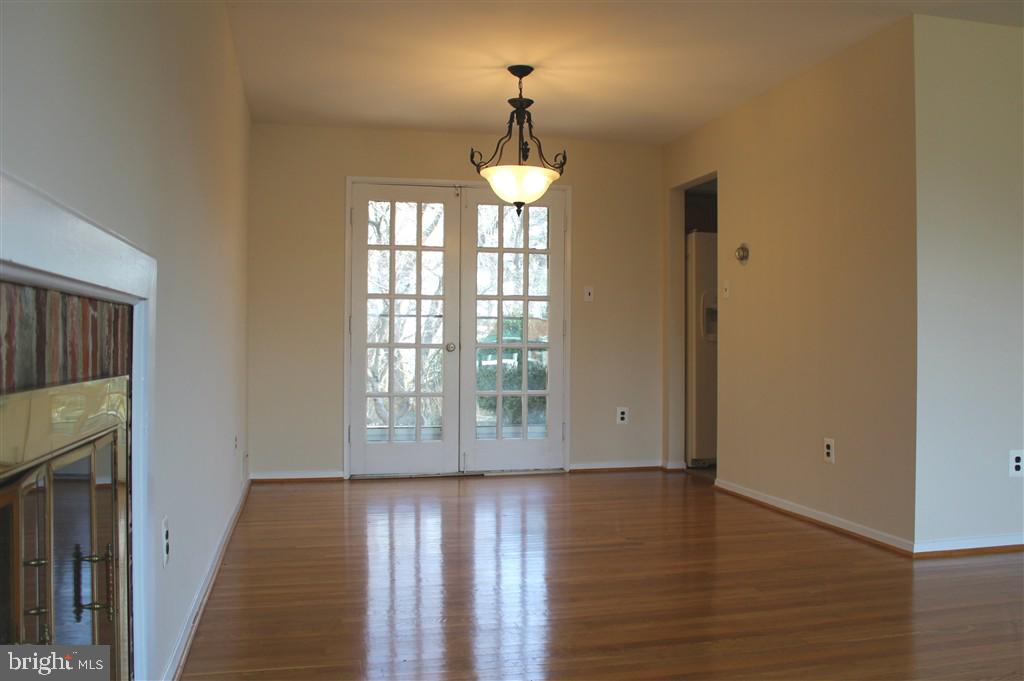 1049 Balls Hill Road McLean, VA 22101 - Photo 4 of 6 a view of an empty room with wooden floor and a window
