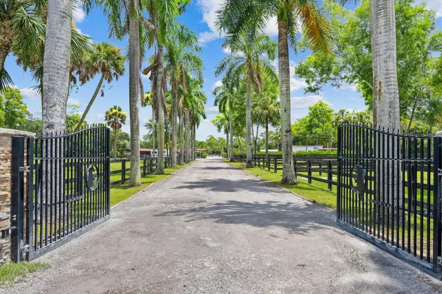 a view of a park with iron fence