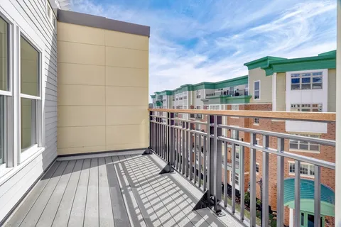 a view of a balcony with wooden floor