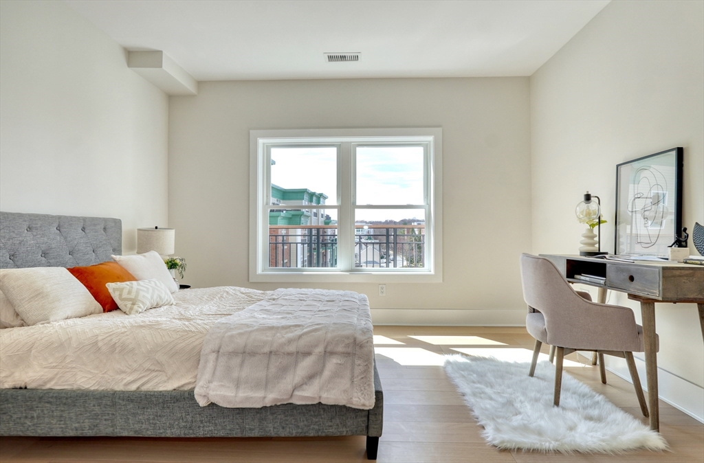 62 Foundry Street, Unit 309 Wakefield, MA 01880 - Photo 15 of 36 a bedroom with a bed and a table